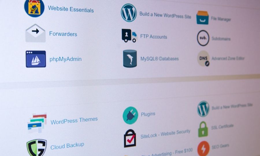 Computer screen displaying various website management tools and icons, including WordPress, phpMyAdmin, MySQL Databases, FTP Accounts, and website security options.
